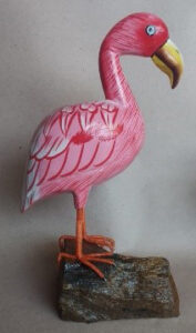 White Flaminggo stay on rock wood carving.